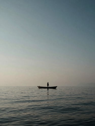 A lone fisherman on a vast misty lagoon in Hue, enormous sky reflecting on water, tiny scale of the boat against the grand horizon, high-contrast natural light, cinematic editorial.