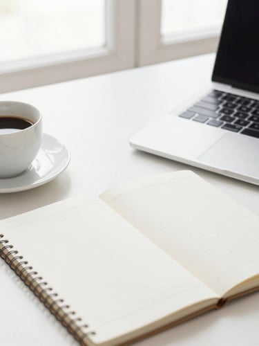 A clean modern workspace flat-lay with a laptop, a notebook, and a cup of coffee, bright natural daylight, soft neutral tones, shallow depth of field