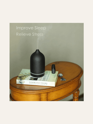picture of a matte black stone essential oil diffuser on a vintage table