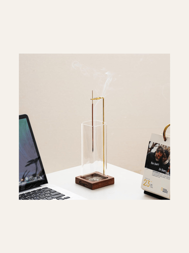 picture of an upside down incense burner with a glass and wooden holder