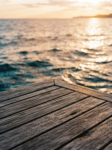 Close-up of weathered teak decking meeting the sea, golden-hour marine light, soft natural reflections, 35mm