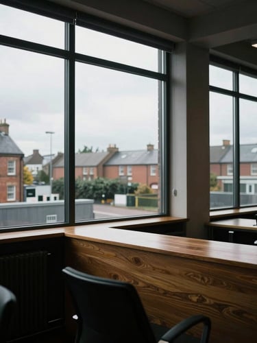 Wide environmental shot of a moody, high-contrast Lancashire office space, natural overcast British light through large windows, sharp focus