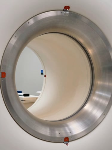 Macro extreme close-up of a high-end MRI scanner's brushed aluminum ring, soft indirect architectural lighting, clinical precision, ultra-clean composition.
