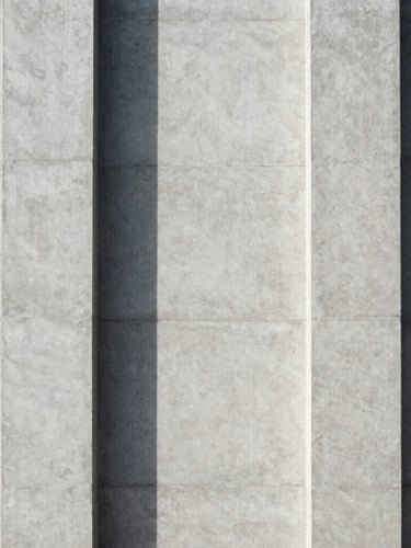 Perfectly centered architectural detail of a concrete facade, sharp linear shadows dividing the frame, clean minimalist geometry.