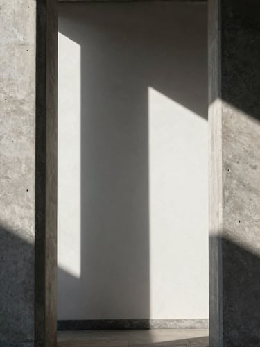 Perfectly centered architectural shot of concrete pillars casting sharp, geometric shadows on a white wall, high-contrast directional natural light, minimalist composition.