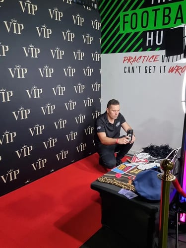 Kahn from SweetAz Co. setting up the VIP red carpet booth for Josiah's birthday in Albion.