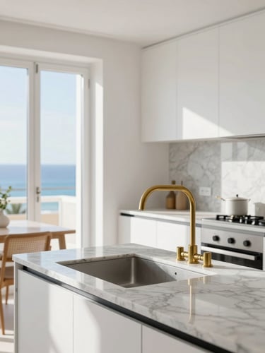 Premium architectural photography of a bright modern Spanish apartment kitchen, natural Mediterranean daylight, clean details of marble countertops and brushed brass fixtures, sharp focus, 35mm