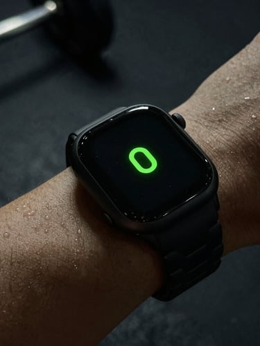 Macro close-up of a sweat-beaded wrist wearing a rugged black alloy smartwatch, optical sensor array glowing bright neon green against dark gym background, dramatic side-lighting, 35mm