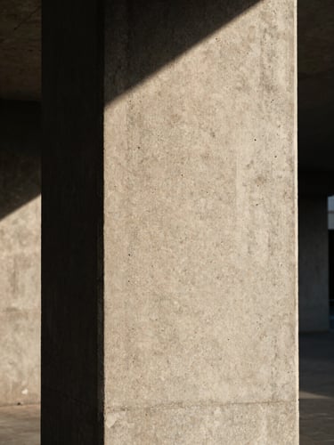 Vertical portrait of a concrete pillar under harsh afternoon sun, emphasizing the raw texture and sharp shadow line, eye-level perspective.
