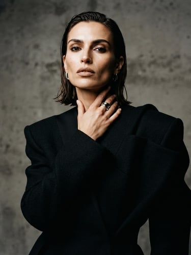 High-fashion editorial portrait of a model, sharp studio lighting, high contrast, minimalist background, neutral tones, medium format film