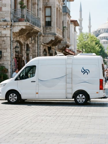 Clean modern white service van with subtle blue branding parked on a clean Istanbul street, bright daylight, professional high-tech commercial photography, 35mm