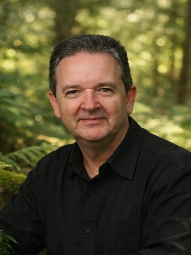 Bruce Clifton spiritual author founder of The Spiritual Centre photographed in woodland natural light