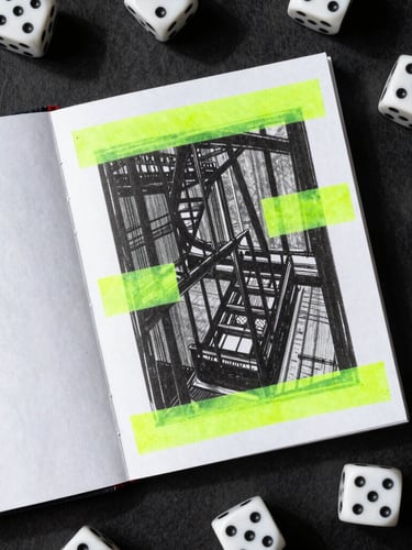 Overhead flat-lay of a photocopied zine booklet with harsh shadows, dice scattered on textured black paper, neon green highlighter marks on the page