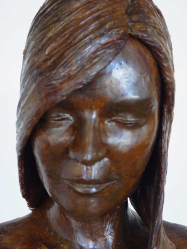 wax detail of a woman's face with long hair 