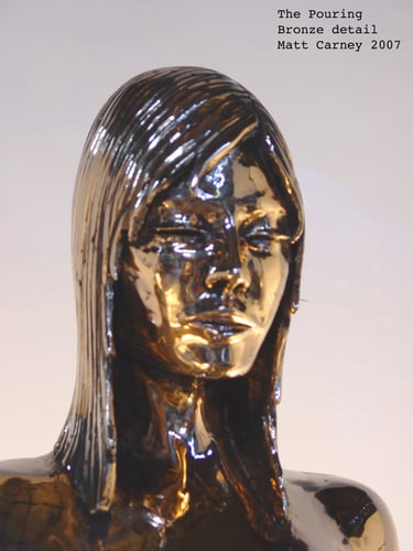 Shiny bronze sculpture of a woman pouring from a carafe face detail