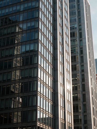 High-contrast architectural detail of modern Istanbul Levent business district, sharp natural light cutting through glass, deep shadows.