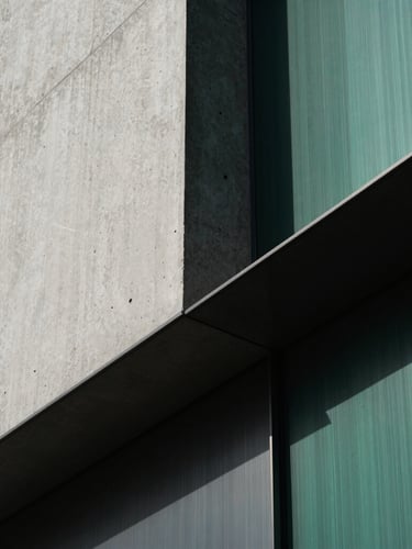 Extreme close-up detail of modern raw concrete and brushed steel architectural lines, sharp diagonal shadows, dramatic side-lighting, minimalist luxury finance aesthetic, 35mm