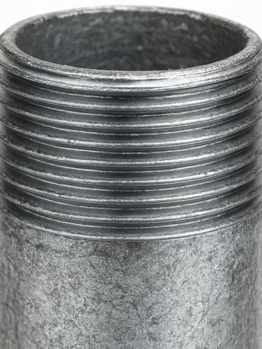 Macro shot of the fine threads on a galvanized steel pipe fitting, bright, even studio lighting, sharp focus, seamless white backdrop, 50mm lens. Portrait aspect.