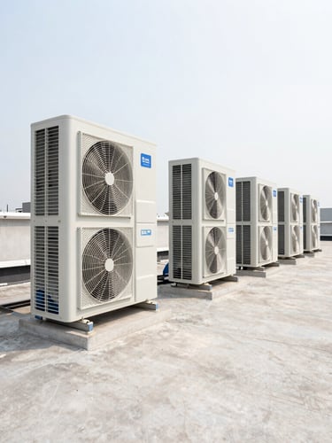 Wide-angle technical shot of modern commercial HVAC units on a bright, clean industrial rooftop, high-visibility daylight, precise alignment, negative space on the right.