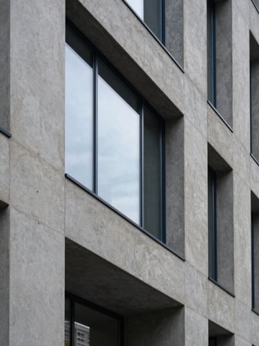 Architectural detail of a modern concrete and glass law office, soft side window light, muted navy and stone tones, sharp focus, 35mm