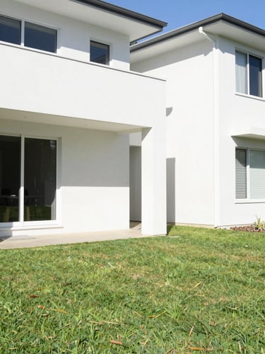 Bright natural sunlight on a modern Perth home exterior with crisp white walls and a manicured green lawn, 35mm photography