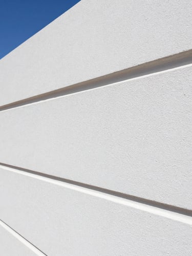 Sharp close-up of clean paint lines on a modern rendered wall under bright natural Western Australian sunlight, crisp details, 35mm