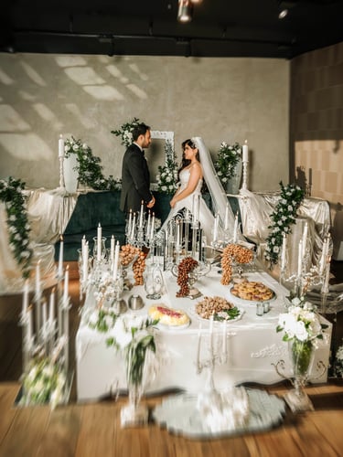 Bride and groom facing each other at Sofreh Aghd setup, captured by Fred Art Studio
