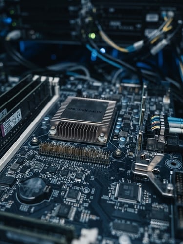 Macro photograph of physical computing hardware, server rack circuit board, cool ambient studio light, desaturated charcoal and electric blue tones, shallow depth of field