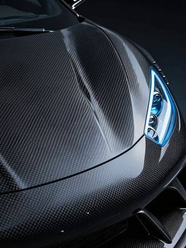 Extreme close-up of a carbon fiber aerodynamic panel on a premium vehicle, cold blue rim lighting, dark studio environment