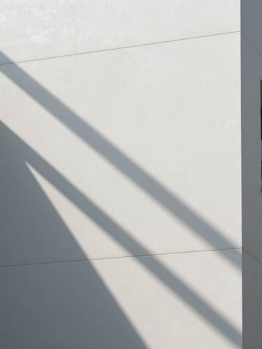 Sharp directional sunlight casting graphic linear shadows on a clean white architectural facade in Hong Kong, minimalist, high-contrast, premium corporate aesthetic.