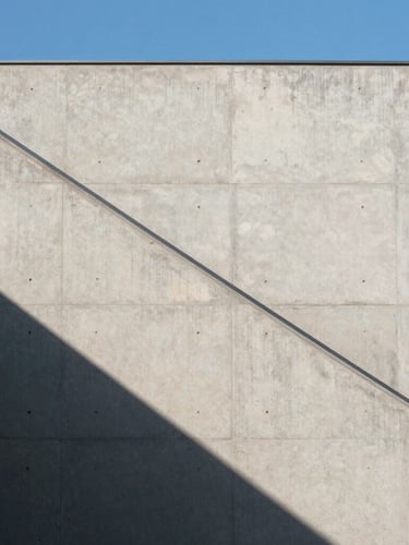 Minimalist architectural shot of clean concrete lines in Hong Kong, sharp directional sunlight casting diagonal shadows, high contrast, blue sky element.
