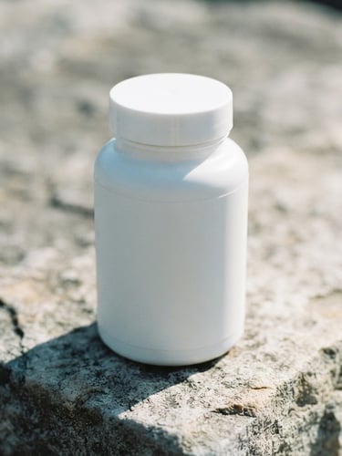 Crisp close-up of clean, minimalist supplement packaging on a raw stone surface, bright natural morning daylight, high contrast, 35mm lens