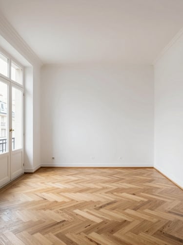 Straight-on architectural wide shot of a newly renovated Parisian apartment living room, flawless white walls, restored oak parquet flooring, natural daylight flooding from a large window on the left, minimalist modern furniture, clean lines.