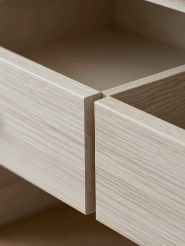Extreme close-up of a flawless grain-matched white oak drawer joint, showing immaculate furniture-grade joinery under soft diffused side-lighting