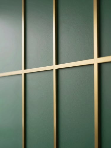Close-up of elegant architectural details in a modern office, soft natural daylight, deep forest green and gold accents, clean minimalist composition, 35mm