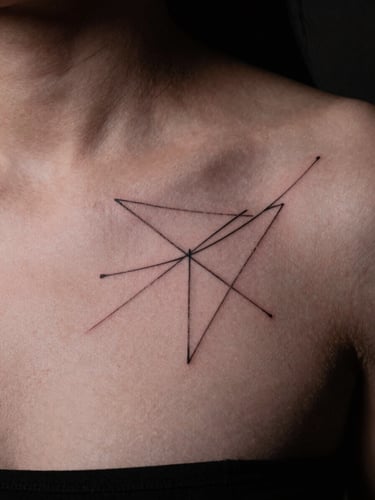 Sharp macro shot of a delicate fine-line abstract geometric tattoo on a collarbone, clean skin texture, moody studio key light, 35mm film
