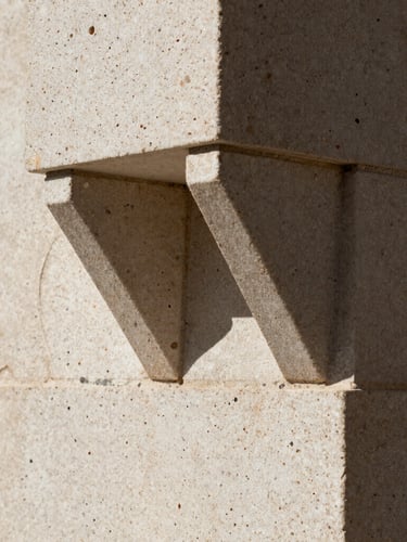 Macro close-up of a sharp geometric shadow cast on a raw travertine stone wall, harsh natural sunlight, high-contrast, architectural detail