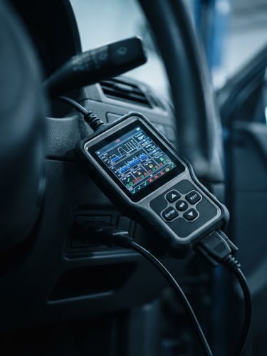 Macro shot of a diagnostic screen plugged into a car dashboard, cool-toned workshop lighting, sharp focus on the digital interface, 35mm lens