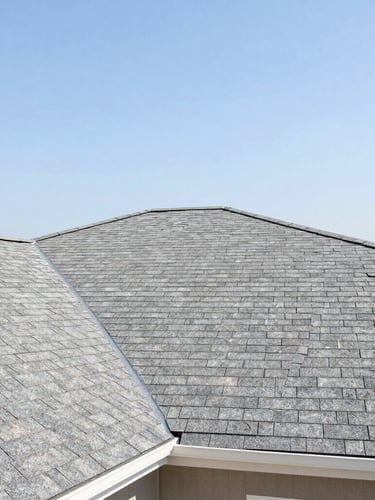A clean residential roof line with newly installed architectural shingles under bright Texas daylight, crisp natural colors