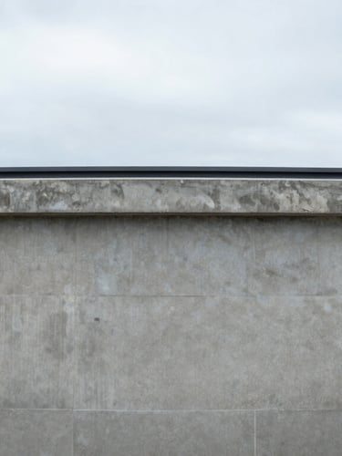Top-down architectural elevation of a concrete water treatment basin, sharp technical focus, cool overcast daylight, desaturated gray and soft blue tones.
