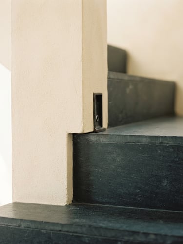 Minimalist architectural detail showing structure and boundaries, soft natural daylight, warm cream and deep slate tones, editorial framing.