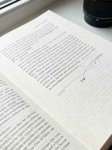 A top-down flat-lay of a printed book manuscript with editorial pencil markings on crisp textured paper, soft natural window light, 50mm lens