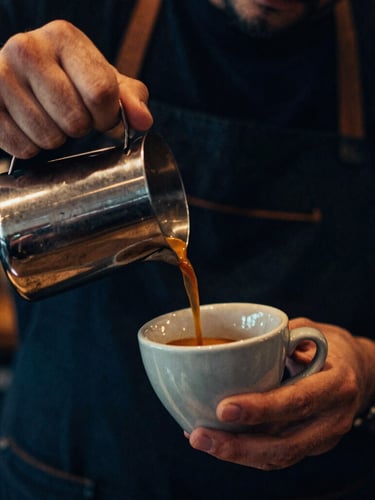 Close-up portrait of a barista pouring a double shot of espresso into a ceramic cup, warm amber lighting, deep blue shadows, 35mm film