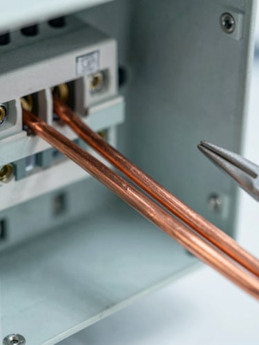 Close-up macro shot of clean copper wiring inside a modern electrical panel, professional tools nearby, bright natural daylight, crisp industrial photography, sharp focus, 35mm lens