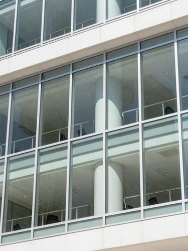 Bright natural daylight shot of a modern glass office building facade in St. Petersburg Florida, clean architectural lines, sharp focus, 35mm
