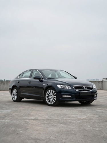 Wide straight-angle front three-quarter exterior of a dark European executive sedan parked on a flat cement surface, neutral overcast daylight, even studio-like illumination showing paintwork condition clearly, no people, no background distractions, minimal shadow, documentary framing