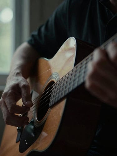 Extreme close-up of hands on acoustic guitar strings, moody natural window light, deep shadows, desaturated forest tones, 35mm film grain