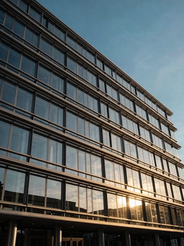 A dramatic low-angle shot of the European Commission building in Brussels, golden hour sunlight reflecting off glass panels, clean geometric lines.