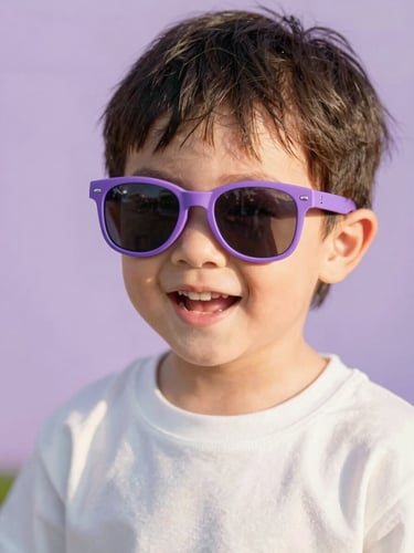 Candid close-up of a happy child playing outdoors, wearing protective purple sunglasses, warm natural golden hour light, soft lilac background, 35mm