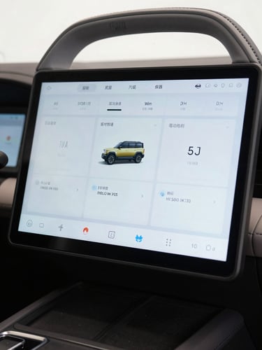 Close-up of iCAR large touchscreen interface showing sharp grid-based UI layout, high-key studio lighting, screen glow reflecting on steering wheel, architectural framing, no people